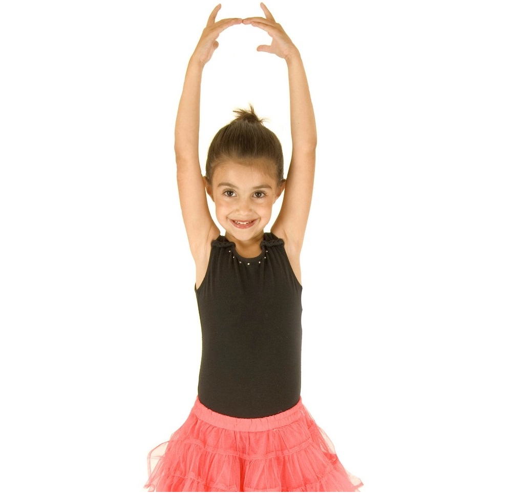 cute young ballerina girl posing with her arms in the air