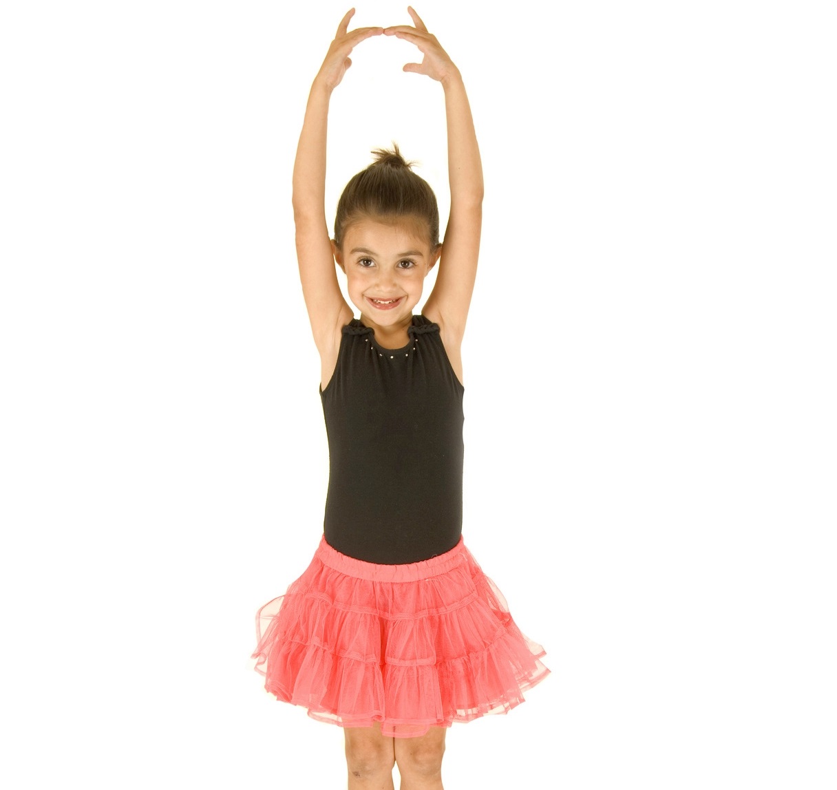 cute young ballerina girl posing with her arms in the air